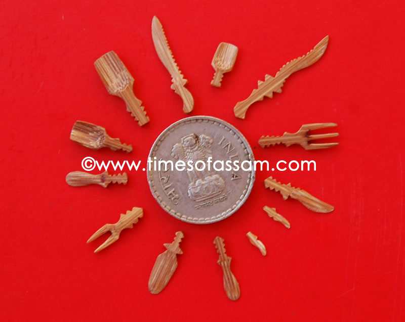 Assamese bamboo cutlery maker Tridib Mahanta (unseen), shows his miniature bamboo cutlery set, consisting of forks, knives spoon etc placed next to a five Rupee coin at the Sivasagar Expo, 2010. For Sell. A Luit Chaliha Photography.
