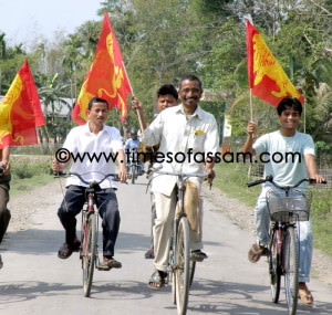 Rajkumar Duwarah (on bicycle, middle) 43 years, All India Forward Bloc candidate for Amguri constituency with his supporters, on his way to campaign in his constituency for the first phase of the upcoming Assam Assembly Elections in Assam, India on 29 March 2011. Duwarah has contested 2004 and 2009 MP elections from the Jorhat constituency and 2006 Assembley elections from Amguri constituency. This is the fourth time he is fighing in the elections. In all the elections he is using the same bicycle and never used any vehicles for his campaigning, even his Personal Security Officer (PSO) has to go with him with a bicycle. Picture by Manash Jyoti Dutta..